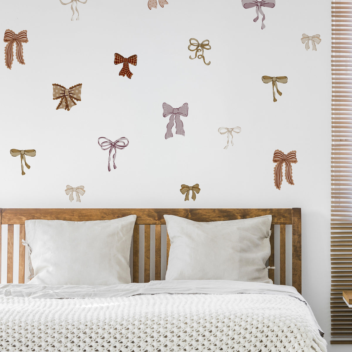 Bedroom with decorative bow decals on the wall above a wooden headboard.