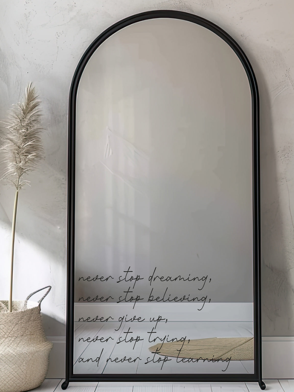 Arched mirror with motivational quote on a neutral background