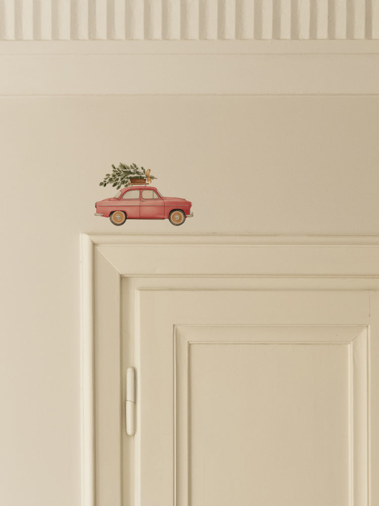 Red Car Carrying a Christmas Tree Door Decoration
