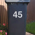 Bin Street Number or Name Sticker used to identify which bin is yours. Shows a white vinyl on a black bin.