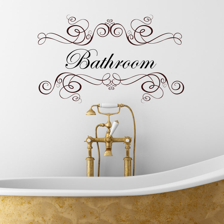 Bathroom Wall Sticker Quote. Word bathroom written in a script style font, with decoration above and below word. shown in brown vinyl on white wall.