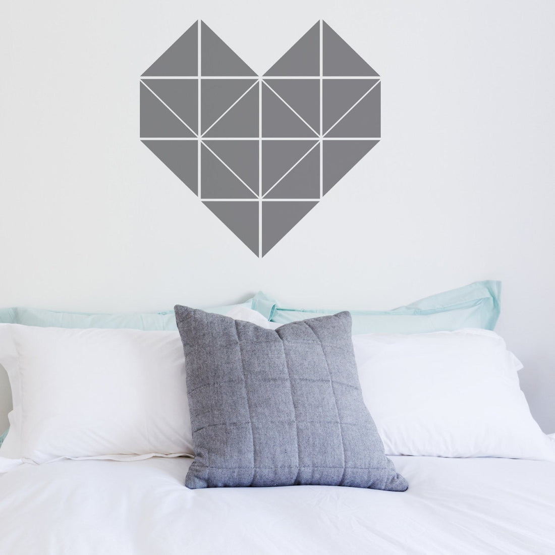 Geometric heart sticker above a double bed 