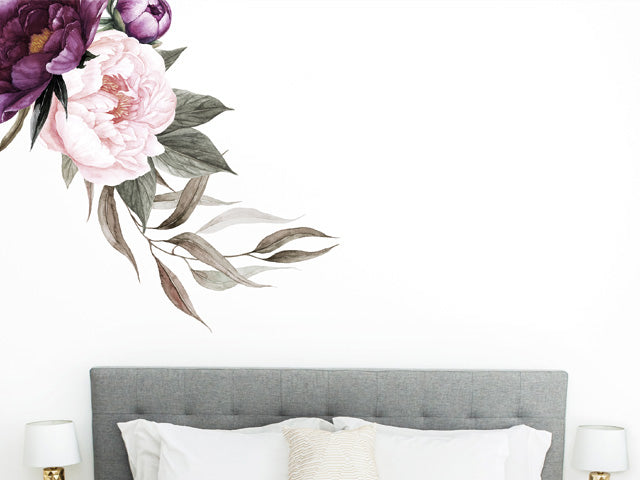 Flower wall art in a bedroom on a white wall.