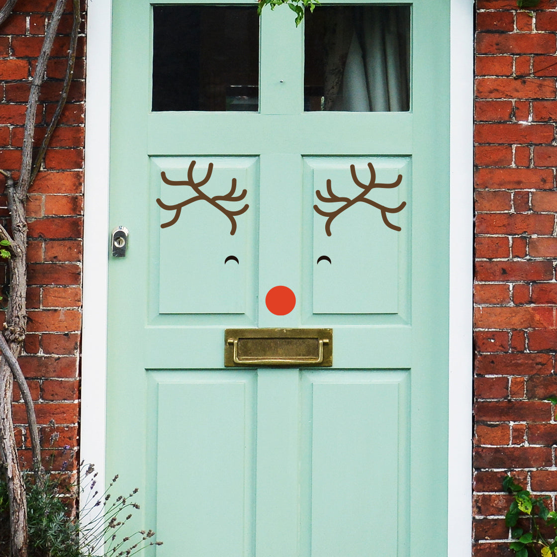 Christmas Door Stickers on a Turquoise Front Door.