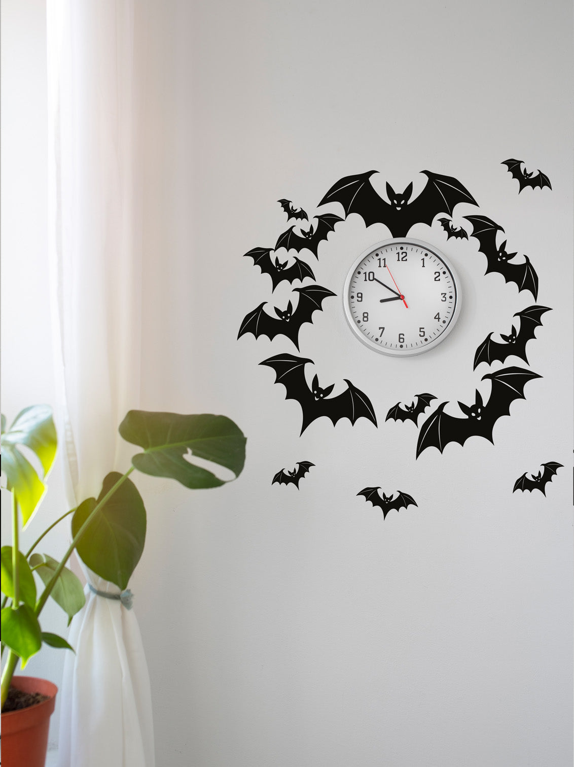 Wall clock with bat wreath wall sticker designs on a white wall