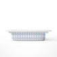 A small rectangular storage bin, featuring a light blue and white harlequin diamond pattern with small red dots, shown on a clean white background.