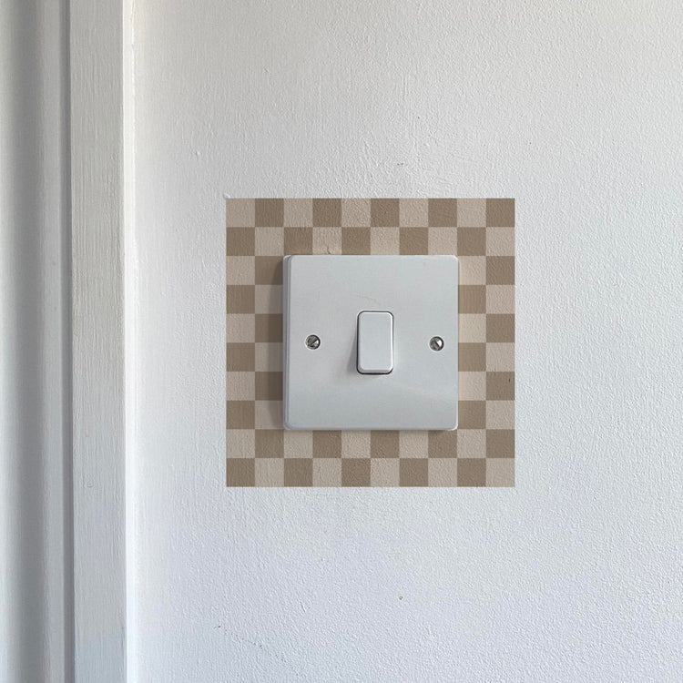 Brown & Cream Chequred_Light_Switch_Decals on a white wall