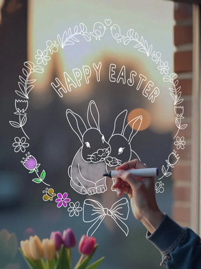 A person coloring in a window sticker with a marker, featuring an Easter-themed design with bunnies and flowers.