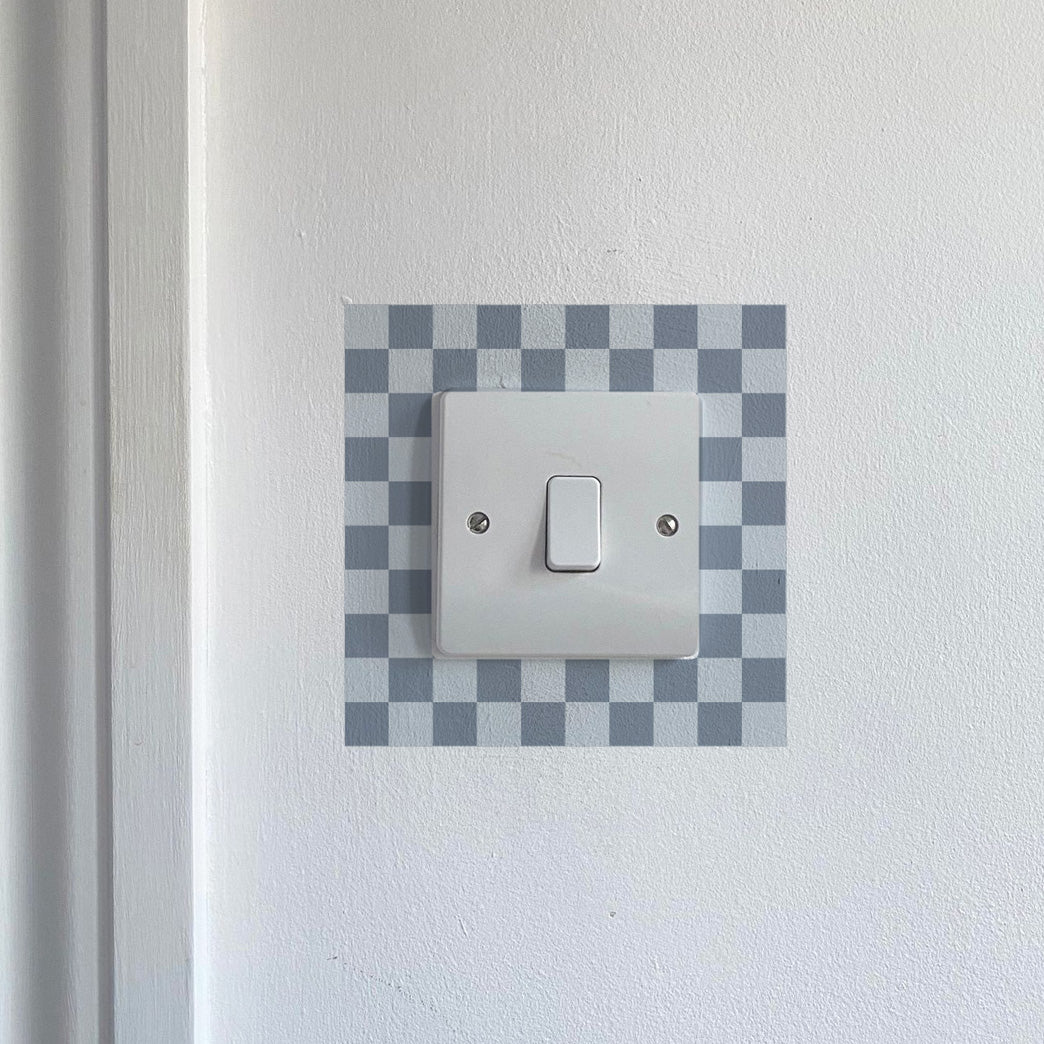 Dark &amp; Light Blue Chequred_Light_Switch_Decals on a white wall