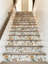 Staircase with floral patterned risers and wooden treads.