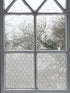 Decorative window with floral patterned film on a gray frame