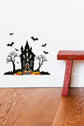 Halloween Spooky Haunted House Wall Sticker sat above white skirting board next to a red wooden stool