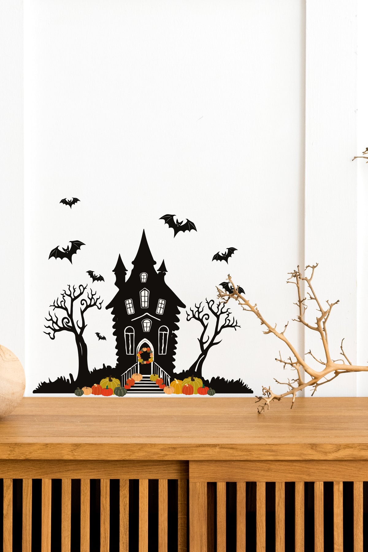 Halloween_Spooky_Haunted_House_Wall_Sticker_Decal placed above a wooden table