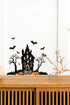 Halloween_Spooky_Haunted_House_Wall_Sticker_Decal placed above a wooden table