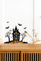 Halloween_Spooky_Haunted_House_Wall_Sticker_Decal placed above a wooden table