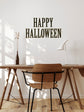 Wooden dining table with chair against a white wall with &