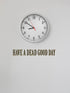 Clock on a white wall with text &