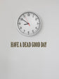 Clock on a white wall with text &