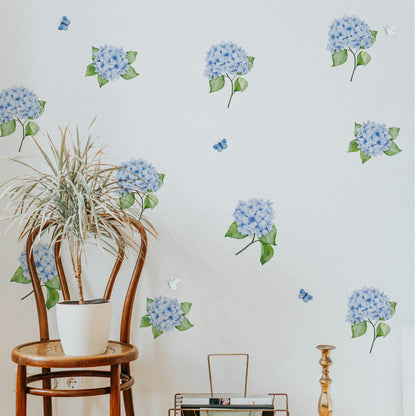 Wall with blue hydrangea and butterflies wall decals and a wooden chair with a plant.
