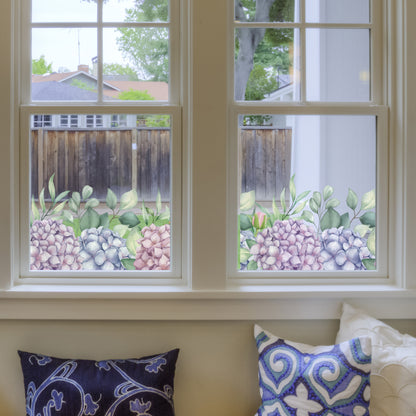 Decorative Hydrangea window Sticker on a window, with pillows on a couch below.