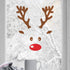 Reindeer face window decal on a frosted glass door with a white mug in the foreground.
