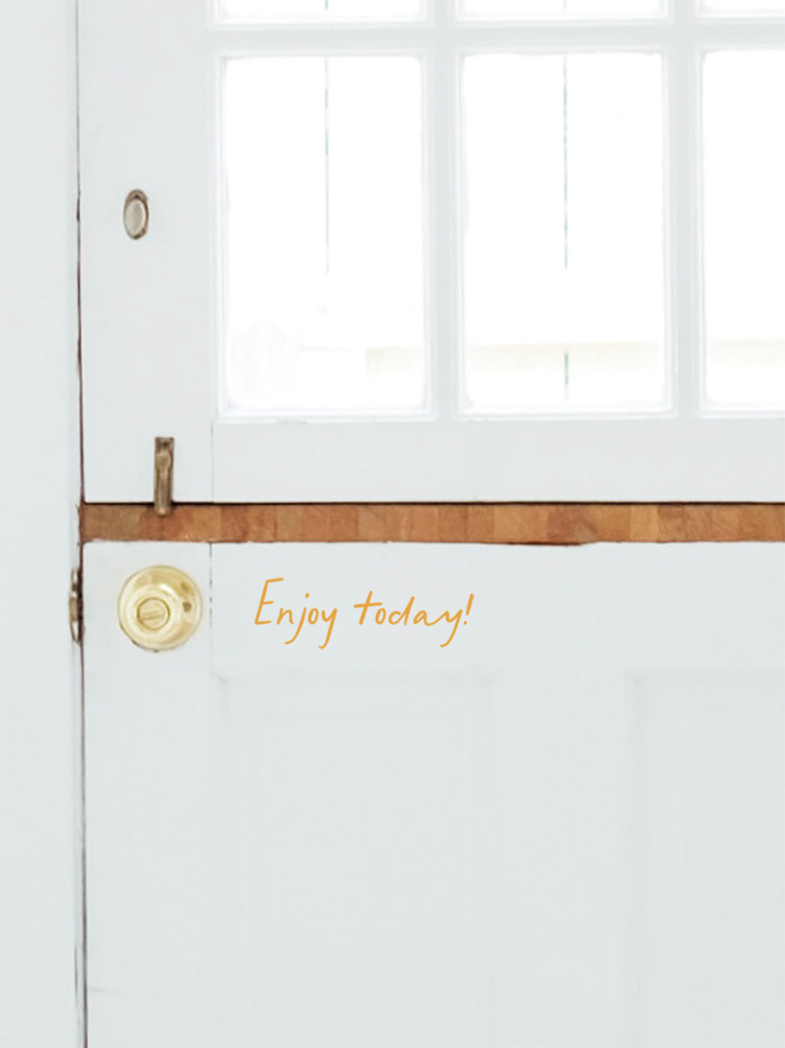 White door with gold handle and &