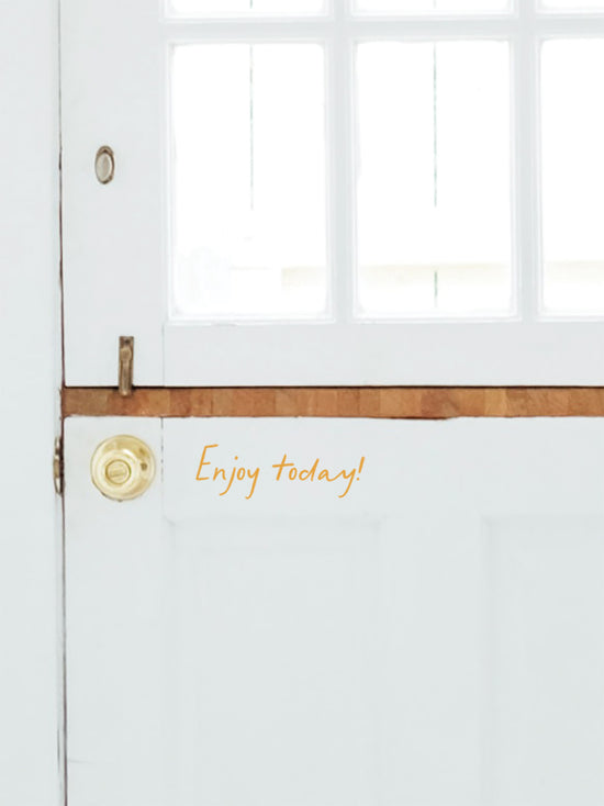 White door with gold handle and &