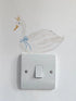 Decorative swan sticker with a crown and blue bow on a light switch.