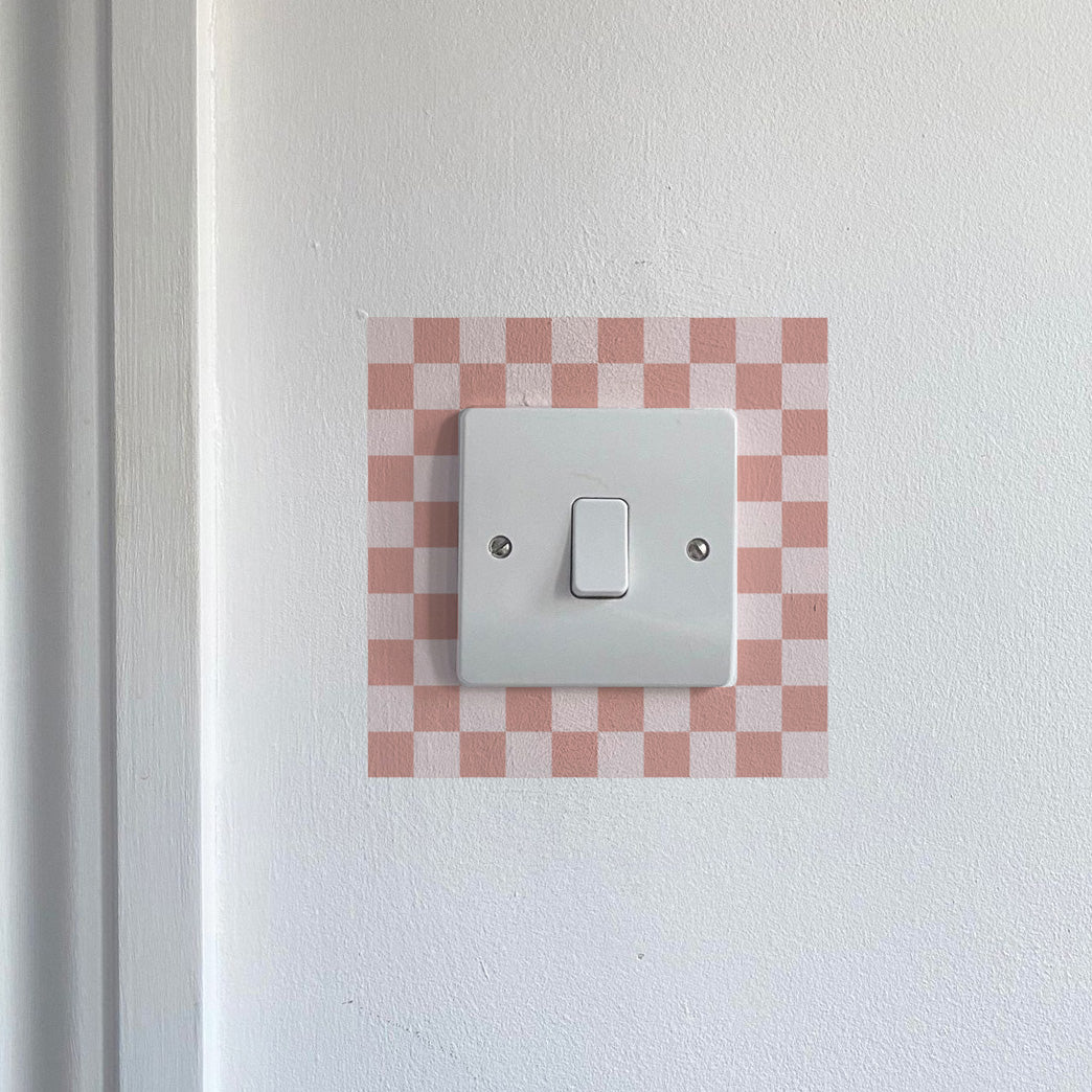 Light Pink Chequred_Light_Switch_Decals on a white wall