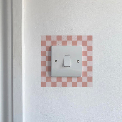 Light Pink Chequred_Light_Switch_Decals on a white wall