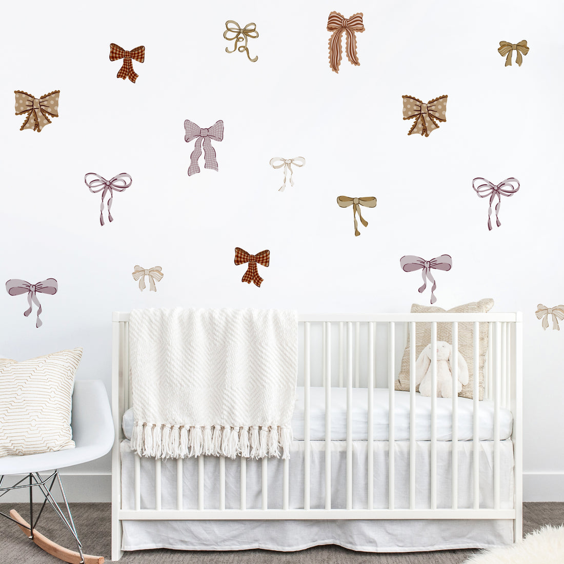 Nursery room with white crib and Mixed bow wall stickers
