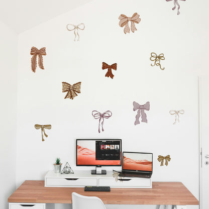 Mixed Bow wall stickers on a white wall above a desk with computer setup.