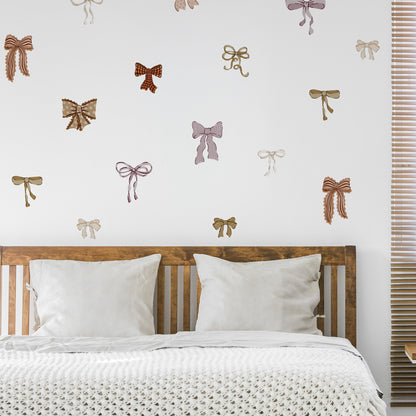 Bedroom with decorative bow decals on the wall above a wooden headboard.