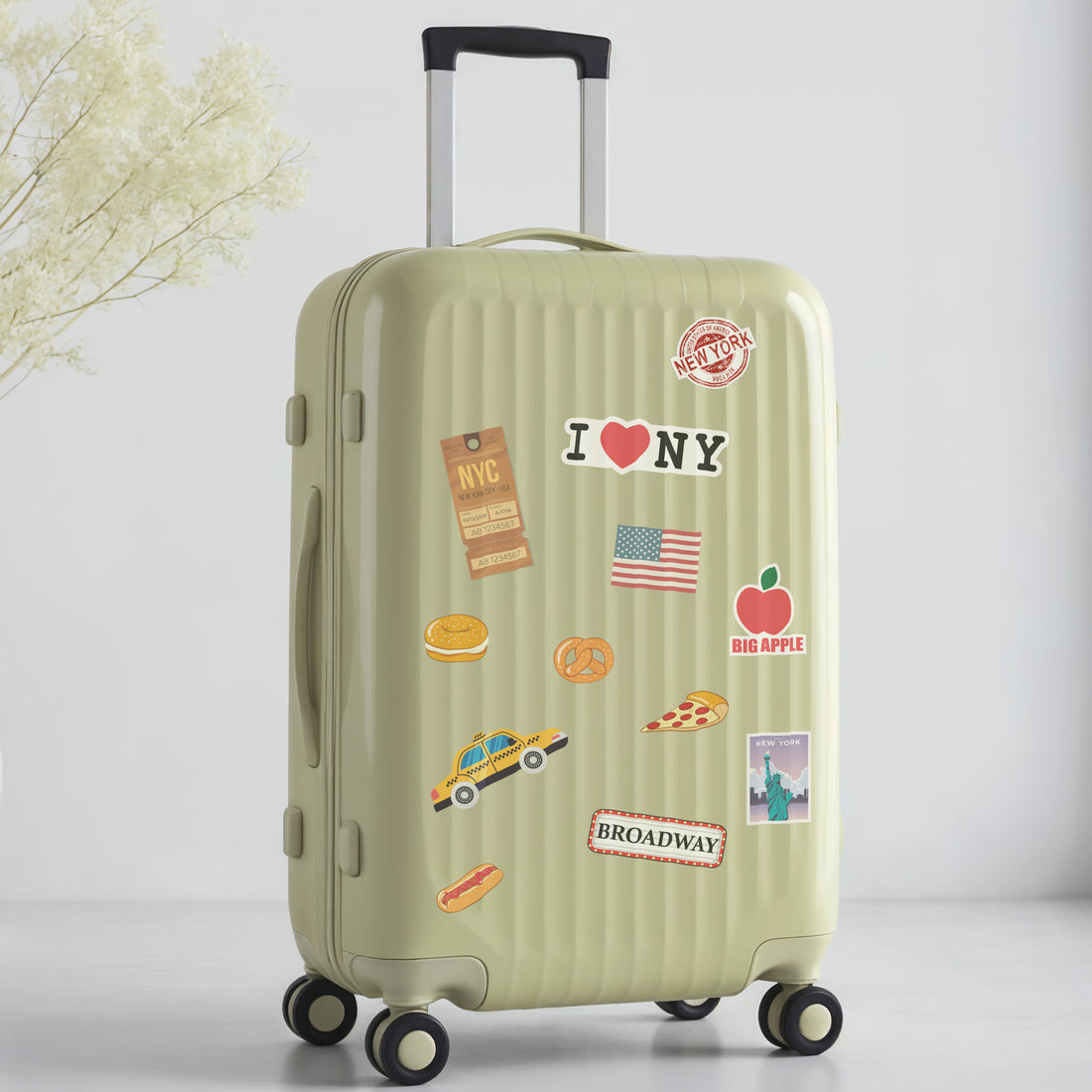 Green suitcase with New York travel-themed stickers on a light gray background