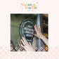 A square promotional graphic with the Nutmeg Studio logo at the top and a central photo of two hands pressing a circular black window decal onto a glass door. The decal features white text reading &