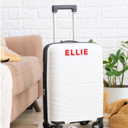 White suitcase with Personalised Luggage Sticker in the name of &