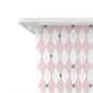 A close-up of a white tub or container edge with a pink and white harlequin diamond pattern wrapped around it, accented with small grey starburst motifs, against a plain white background.
