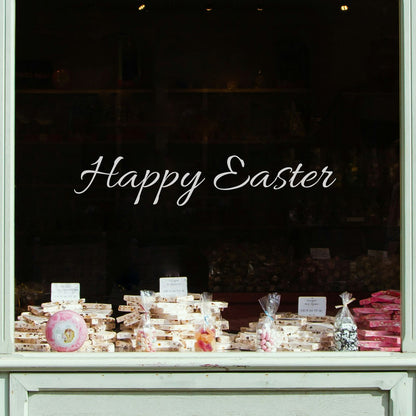 Display of Easter-themed treats in a store window with script writing of &