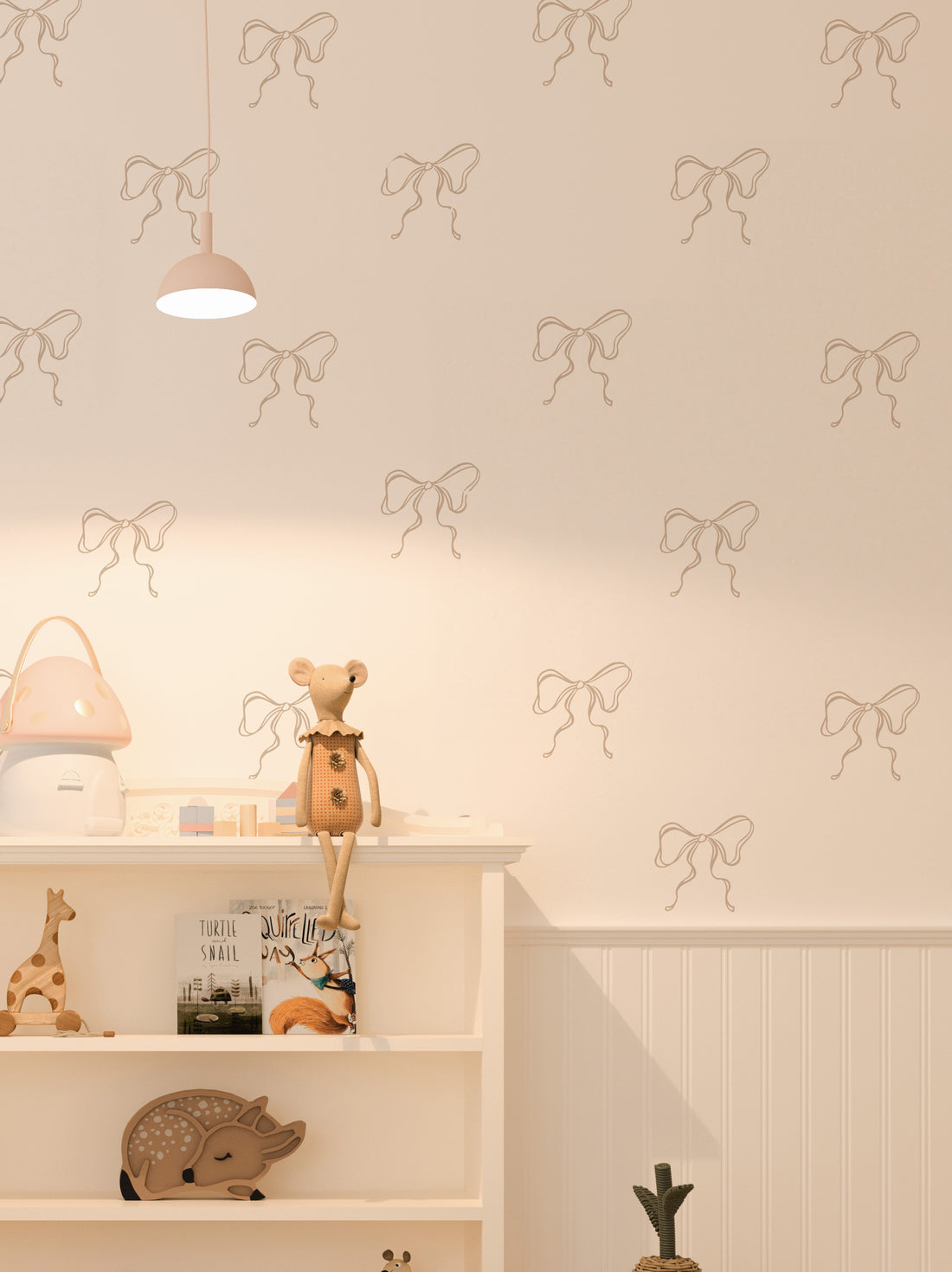 A room with light-colored walls decorated with mushroom coloured coquette bow wall stickers, alongside children&