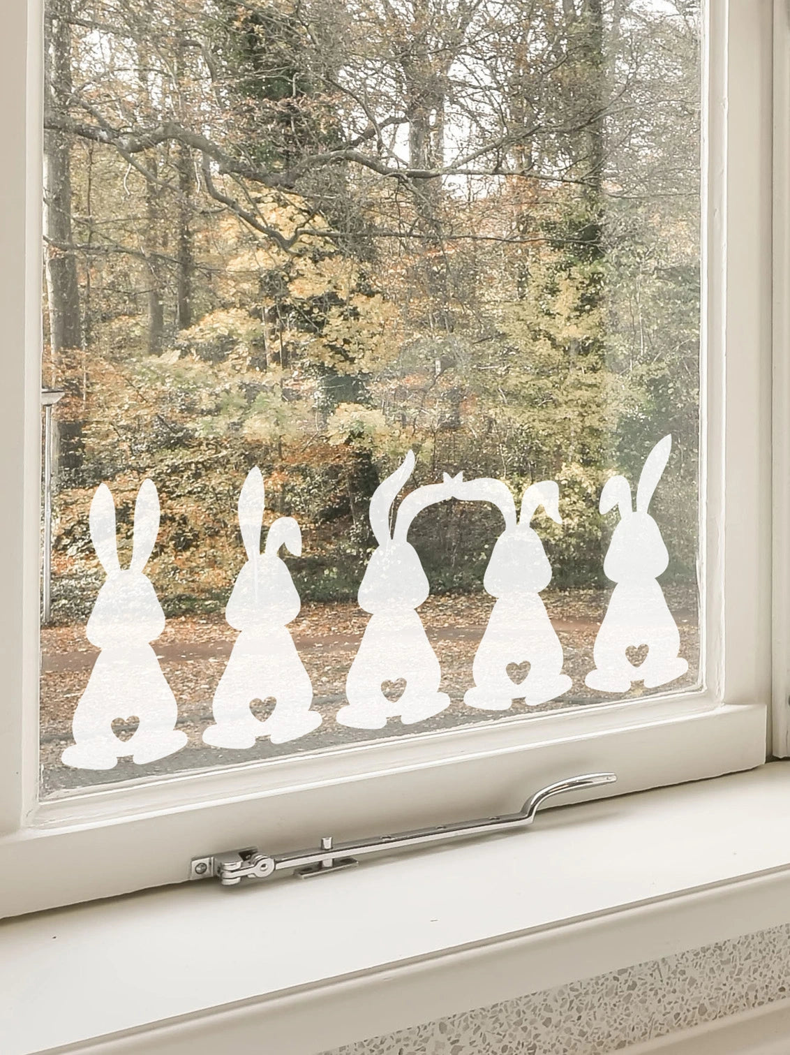 Set of 5 Easter Bunny Window Stickers in a window with trees behind 