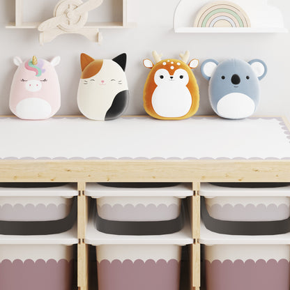 Four plush animal storage bins shaped like a unicorn, cat, deer, and koala, lined up on a light wood trofast storage unit with small drawers in Dusky Lilac and large drawers in Rose Dusk.