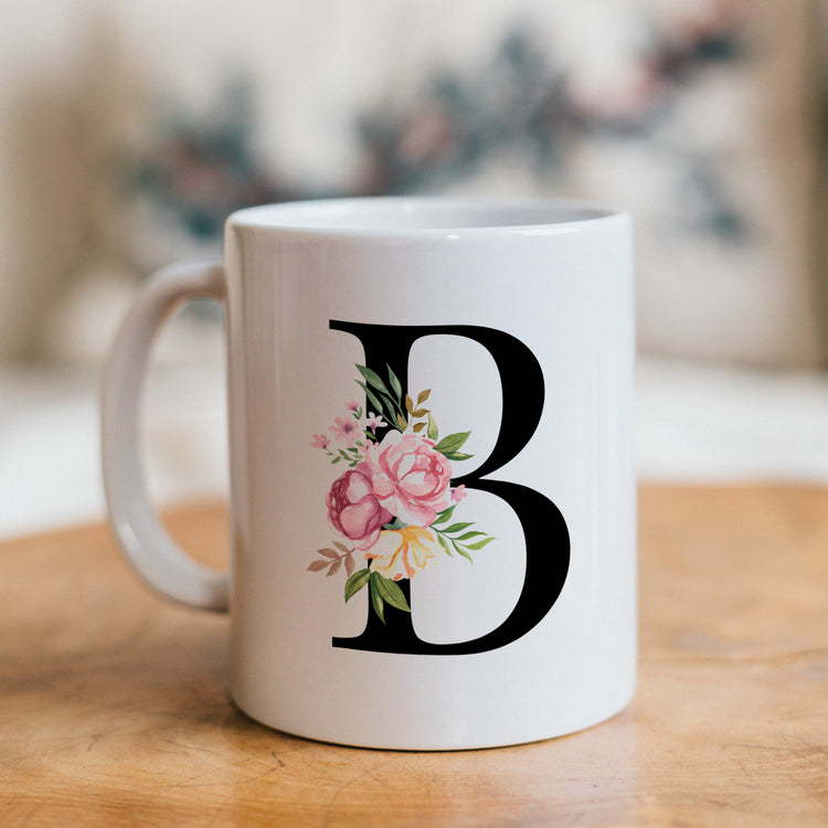 White mug with a black letter &