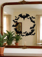 Decorative wall sticker of bats on a mirror with a room reflection.