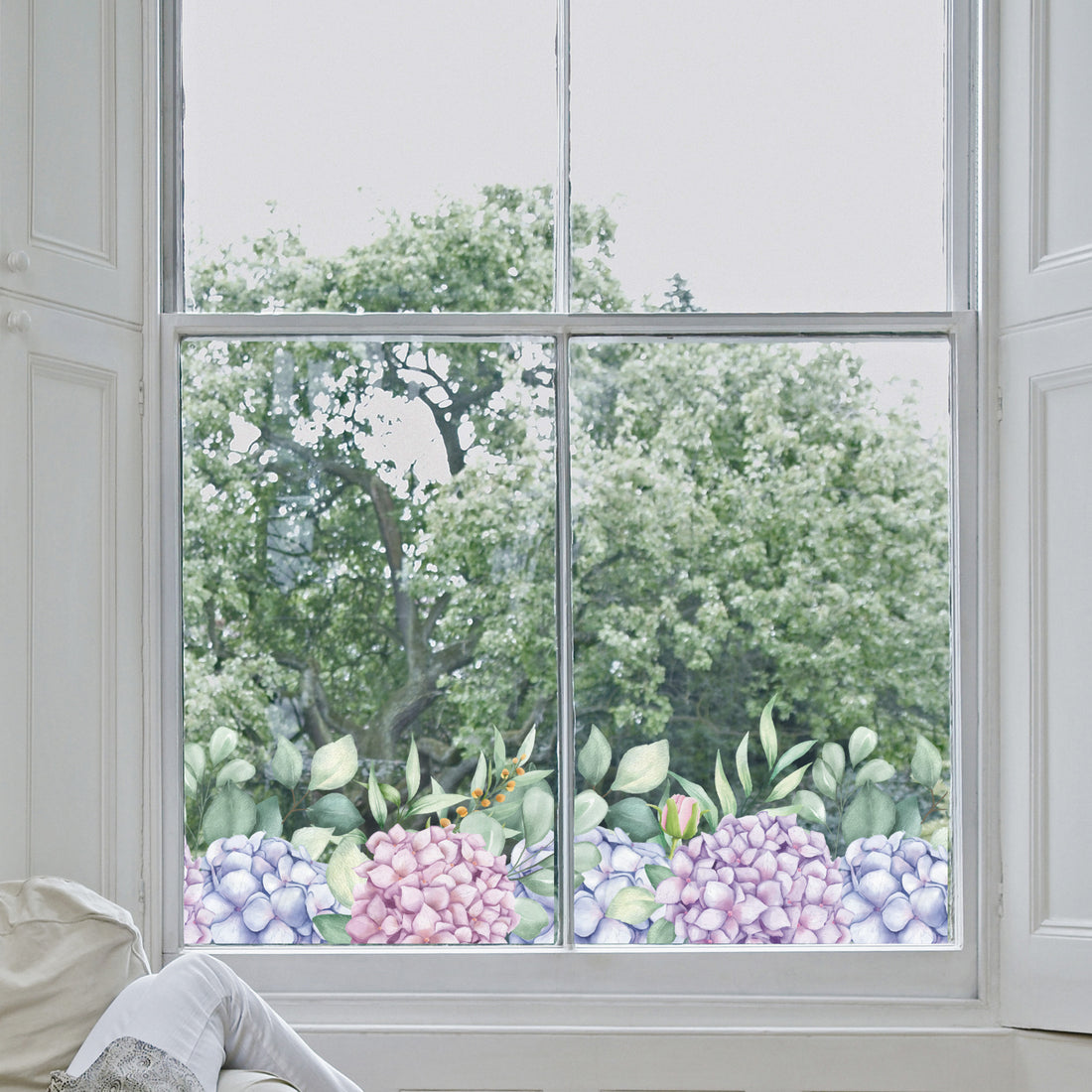 Decorative hydrangea window sticker and greenery on a window