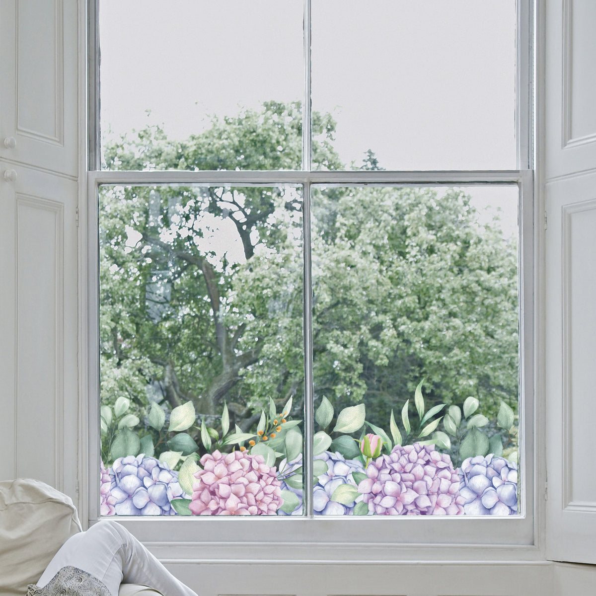 Decorative hydrangea window sticker and greenery on a window