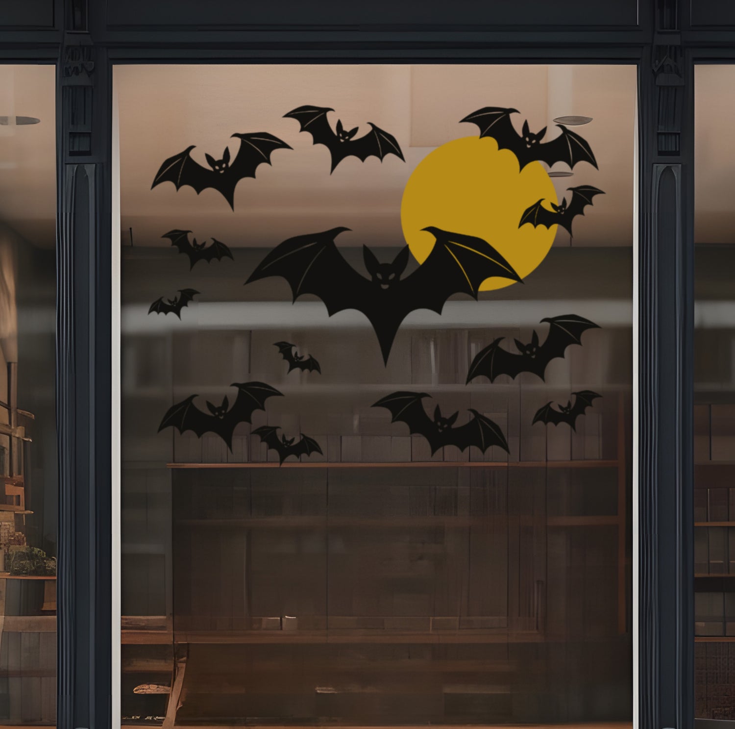 Decorative window with black bats and a gold moon on a dark background