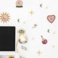 Decorative wall stickers with celestial and mystical designs on a white wall.