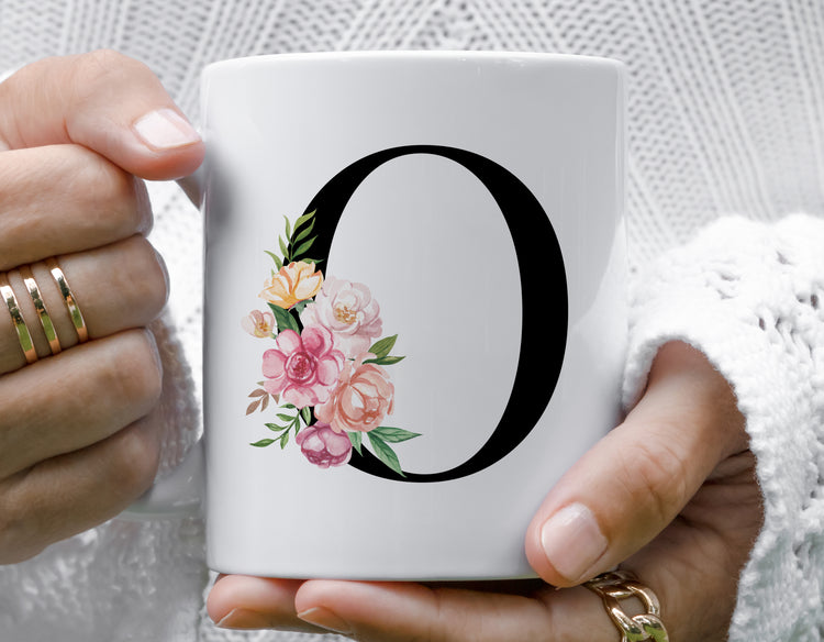 White mug with floral design and letter &