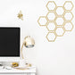 Bee and honeycomb wall sticker in gold on a white wall