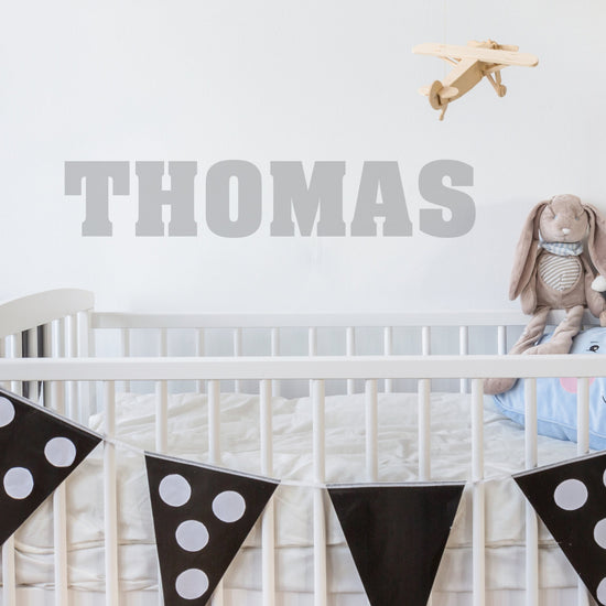 Boys Personalised wall Sticker. Includes a personalised name wall sticker made from vinyl. The image shows the product in a light grey vinyl on a white wall. 